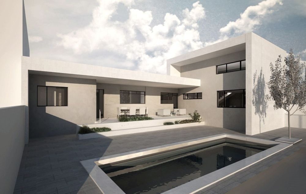 Exterior de vivienda blanca amplia distribuida en L con piscina y terraza
